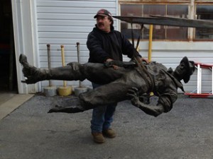 A fragile statue is moved into the new facility