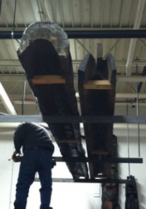 Totem poles are suspended from the ceiling trusses