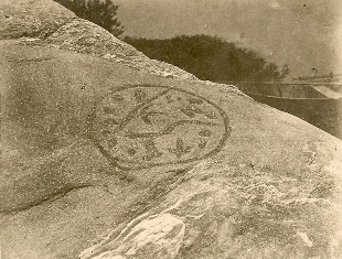 Rock carving on Big Indian rock, 1907. Note the boat in the background. (P1721)